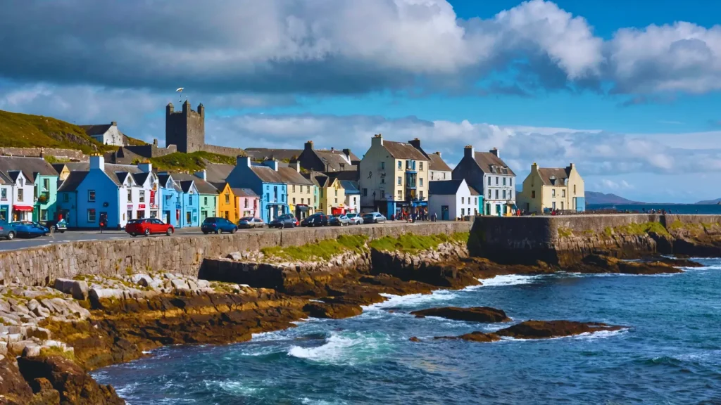 a group of houses on a rocky shore